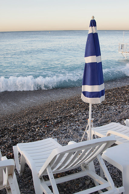 Umbrella and lounge chair on the pebble beach at Nice, France
