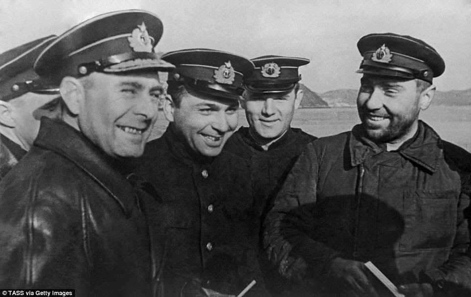Commander of the Northern Fleet Admiral Arseniy Golovko, crew members of the legendary K-21 submarine Zarmayr Arvanov, Commissar Sergei Lysov and K-21 Commander Nikolai Lunin (L-R) pose for a photo at the Northern Fleet base