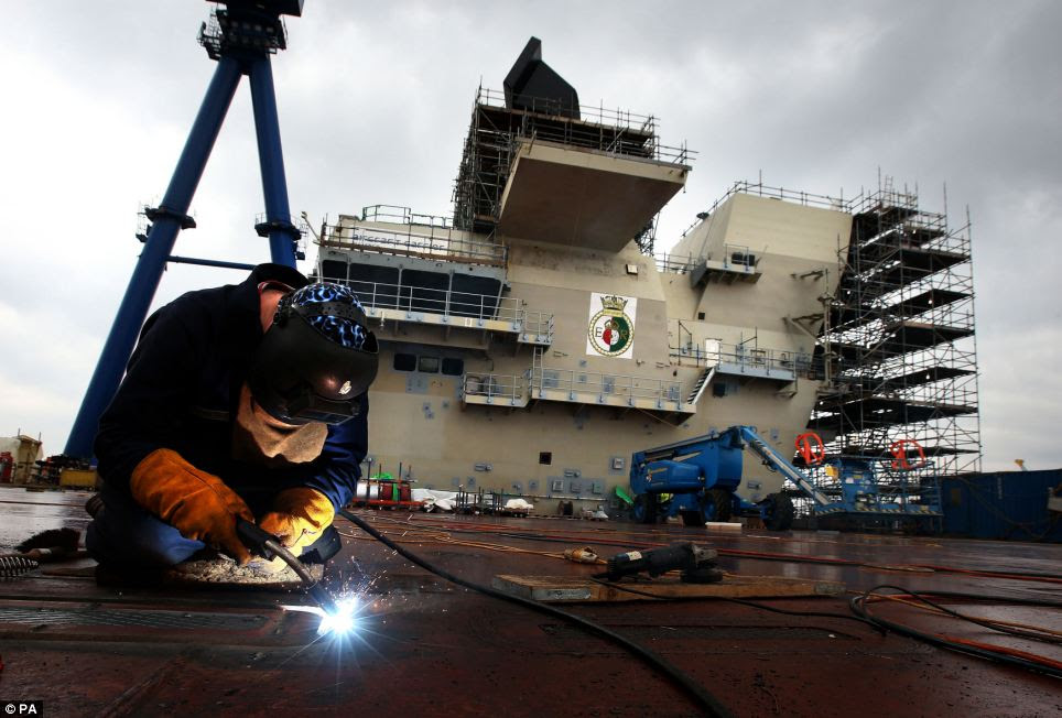 Work continues on building the estimated £6.2billion HMS Queen Elizabeth Aircraft Carrier at Rosyth Docks in Scotland ahead of its official unveiling this summer