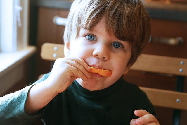 oliver eating an orange