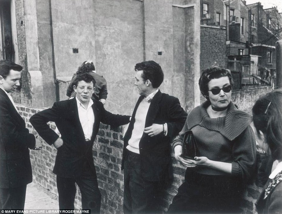 Working class youngsters hang out together in a west London street in 1956Â