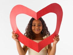Young girl holding paper heart