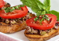 Grilled crostini with olive tapenade and tomato Grilled crostini with olive tapenade and tomato