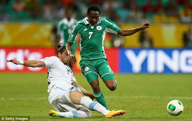 Stuck in: Martin Caceres of Uruguay challenges Ahmed Musa