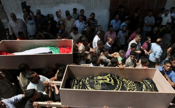 Palestinian mourners carry the coffins o