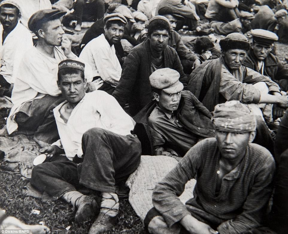 Russian prisoners can be seen huddled together in the haunting images, awaiting their fate at the hands of the Nazis