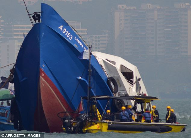 Overnight drama: The bow of the Lamma IV is dragged out of the water following its doomed trip to watch a national day fireworks display in Victoria harbour