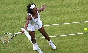 English: Serena stretches for a ball in her fi...