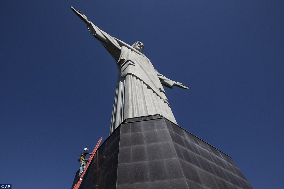 Construction workers have to first scale the statue's platform before they can get inside to climb to the top