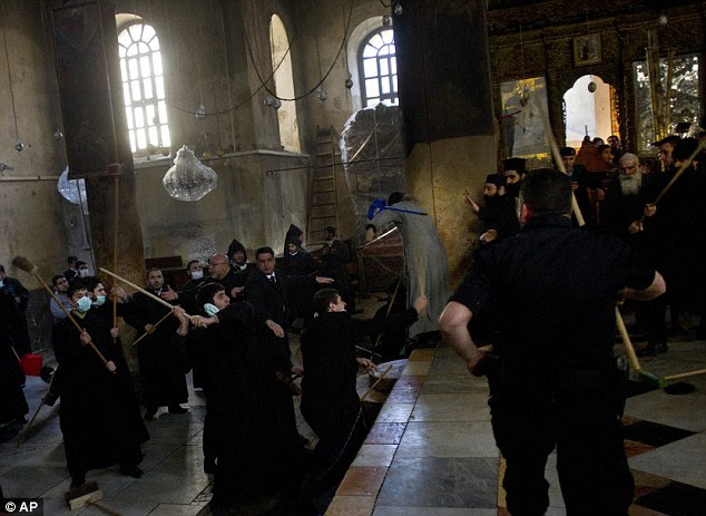 'Guarding their denominational turf': Clerics were said to be defending their areas of the Church when the 100-strong scuffle broke out