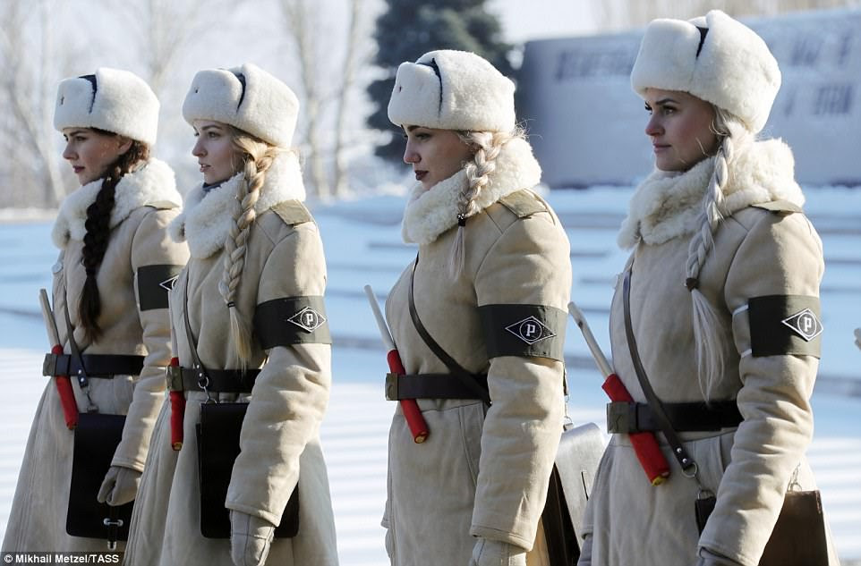 In honour: Young women dressed in the uniforms of World War II-era traffic control officers are lined up during a wreath-laying ceremony at the Mamayev Kurgan memorial complex in Volgograd attended by President Putin