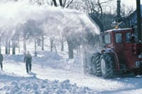 Photo: A snow thrower clearing a street.