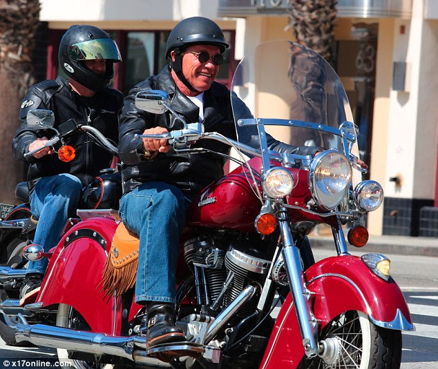 Weekend joy ride: Later in the day, Arnie was spotted going for a ride on his red motorcycle in Santa Monica