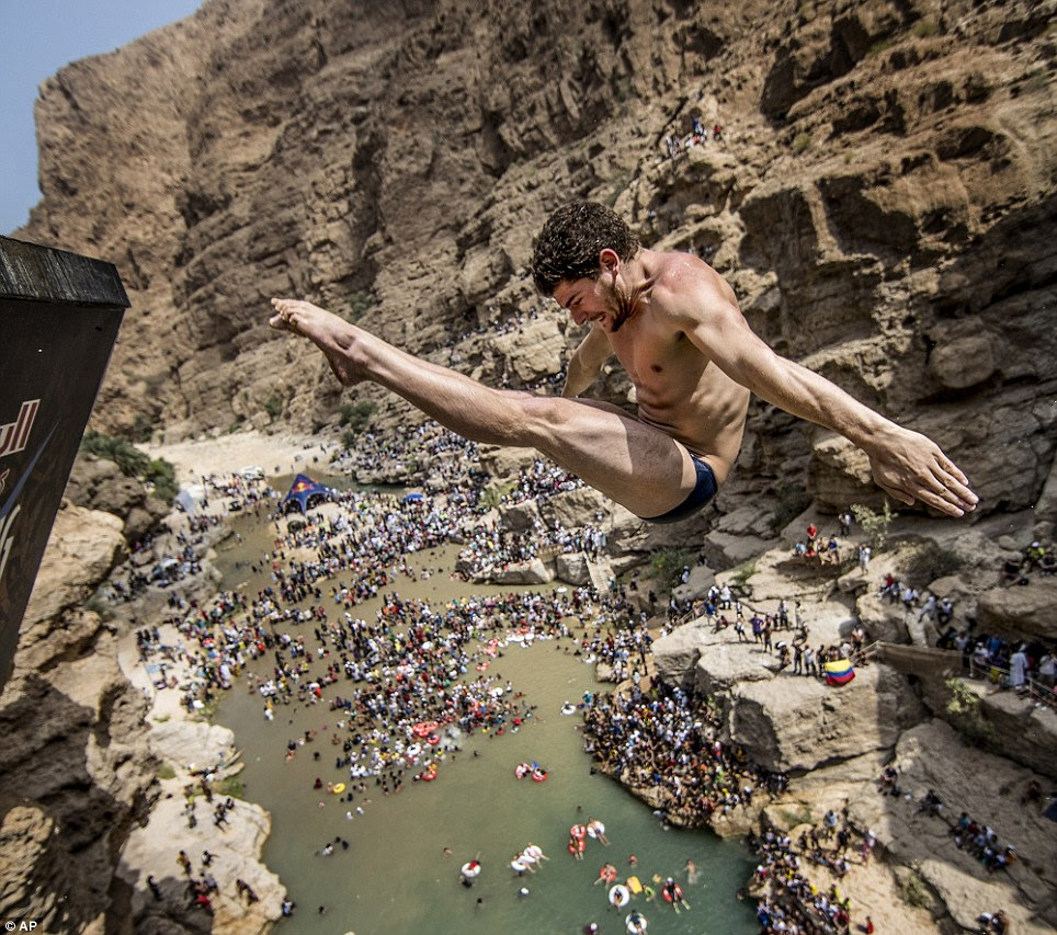 Point those toes! David Colturi of the USA grimaces as he tenses and throws himself into the water