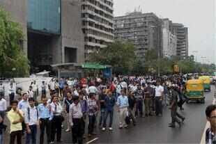 People wait for buses at Connaught Place in New Delhi. People wait for buses at Connaught Place in New Delhi.