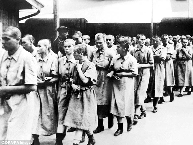 Female prisoners are led away for slave work in the German Reich, at the Auschwitz concentration camp, near Krakow, Poland