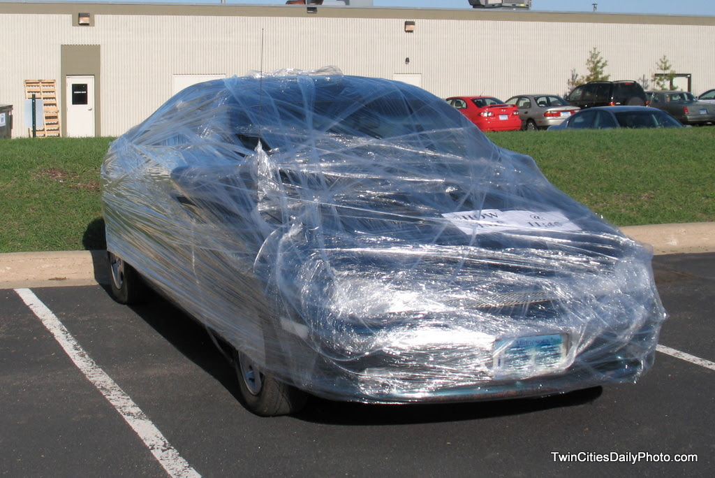 A practical joke was played on a co-worker, they jokers shrink wrapped a vehicle with plastic wrap.