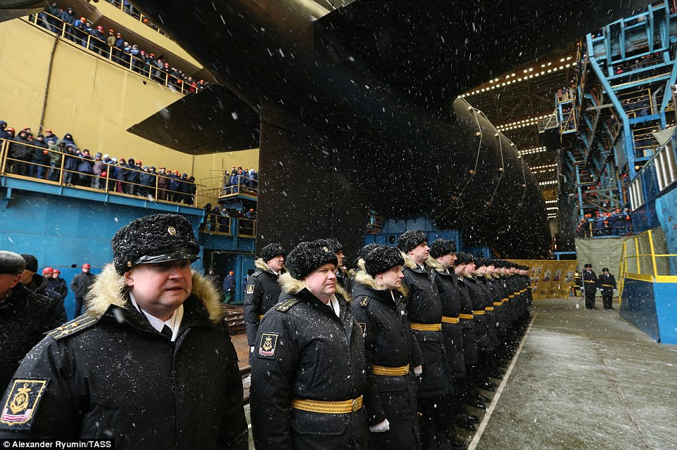These crew members in their snow-covered traditional uniform will be part of the personnel on board when the submarine is launched 