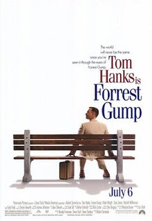 Film poster with an all-white background, and a park bench (facing away from the viewer) near the bottom. A man wearing a white suit is sitting on the right side of the bench and is looking to his left while resting his hands on both sides of him on the bench. A suitcase is sitting on the ground, and the man is wearing tennis shoes. At the top left of the image is the film's tagline and title, and at the bottom is the release date and production credits.