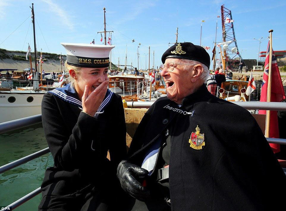 In high spirits: Dunkirk veteran Garth Wright, 95, can be seen laughing and joking with Royal Navy Wren Lauren Parsons as a fleet of some 50 boats arrived in the French port after recreating a journey that saw them save the lives of more than 300,000 British, French and Belgian troops