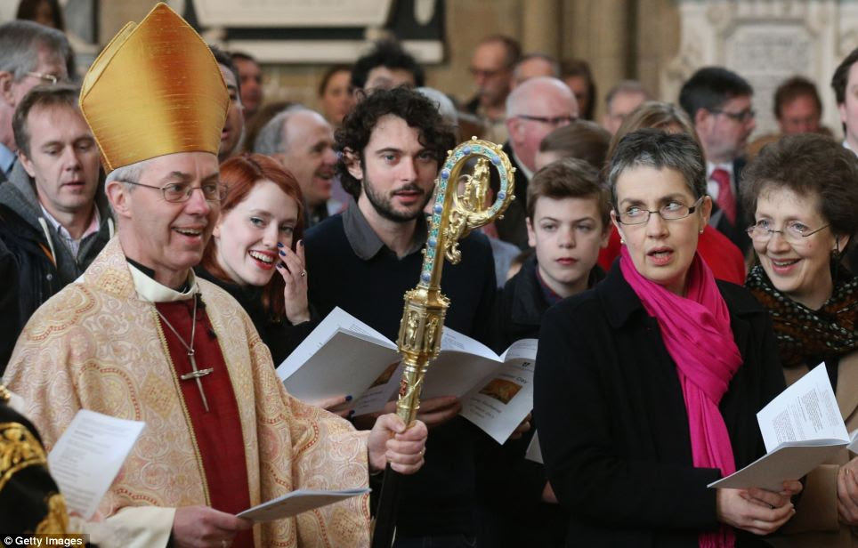 Entrance: Caroline Welby (second right), the wife of the Most Rev and Rt Hon Justin Welby (left), the Lord Archbishop of Canterbury, watches her husband enter Canterbury Cathedral to lead the Easter Sunday service