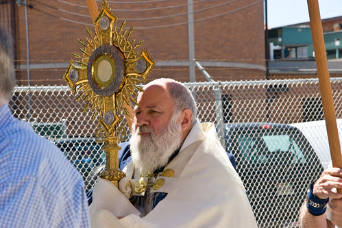 Fr. Paschal Morlinio, OSB Carrying Monstrance with Eucharist by Siena Photo.