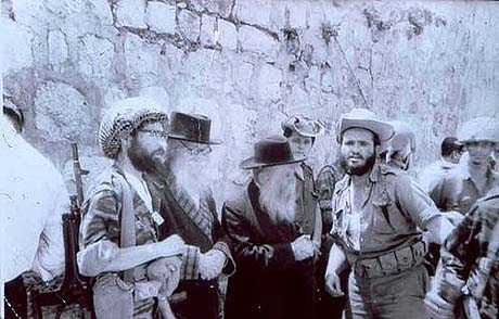 Rabbi Ariel (the bearded paratrooper on the left) bringing his teachers The Nazir and Rabbi Tzvi Yehuda Kook to the Kotel soon after its liberation.