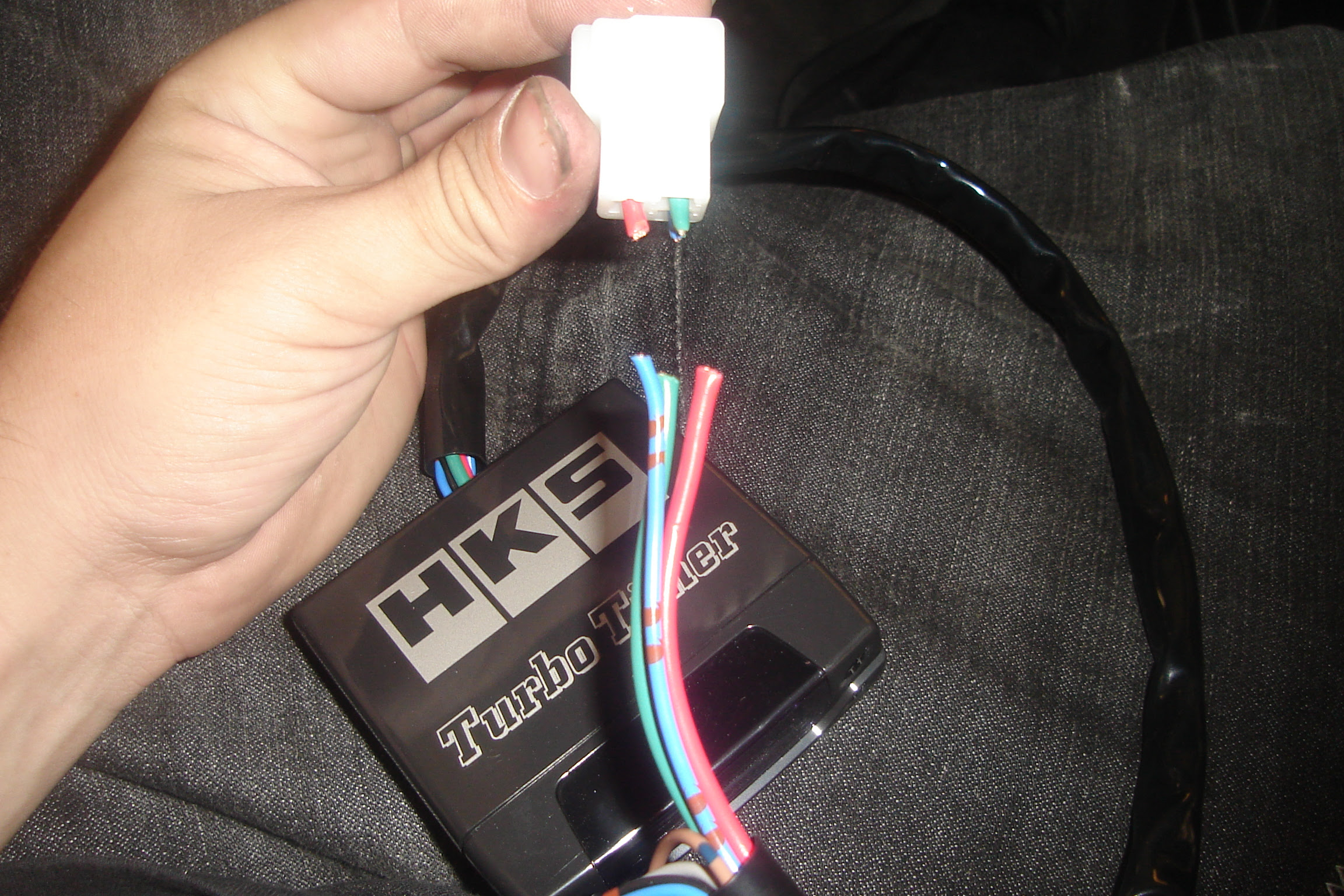 Cutting the harness plug away from the turbo timer