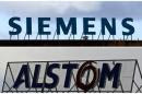 A combination of two file photographs shows the logos of Siemens AG company in Berlin and of French power and transport engineering company Alstom in Reichshoffen