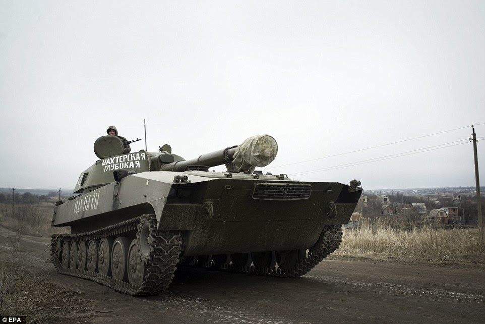 A tank travels along a road near Olenivka village, Donetsk, after rebels appeared to adhere to the ceasefire following their defiance of the peace plan when they launched an attack on Kiev troops a week ago