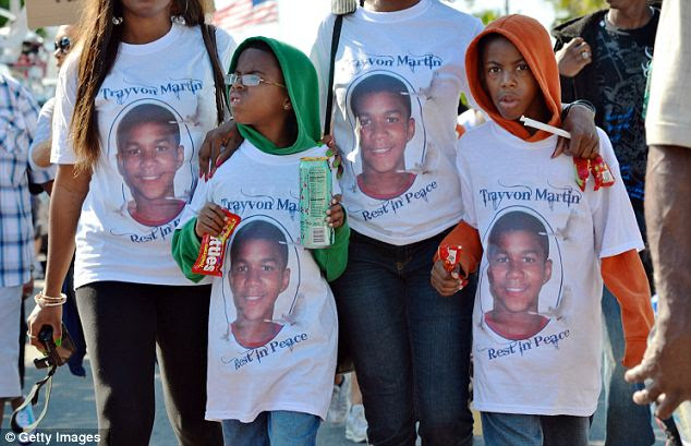 Kitted out: These supporters brought Skittles and Iced Tea with them to the rally, as they were the only two things Trayvon had on him at the time of the fatal incident