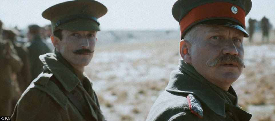 Downing weapons: German and British officers stand shoulder to shoulder in the brief moment of peace before they returned to fighting