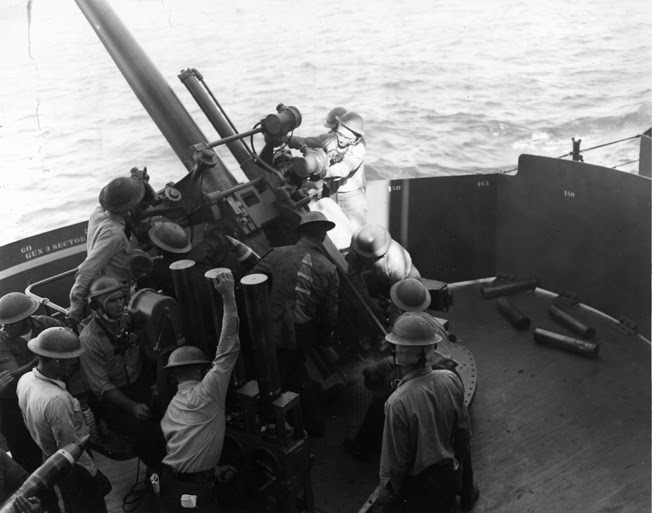 The crew of the USS Astoria's No. 3 gun, a 5-inch weapon, works feverishly during the gunnery practice in the spring of 1942.