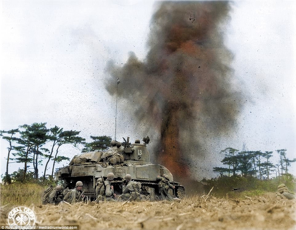 Pictured, an M4 Sherman of 'A' Company 763rd Tank Battalion and troops from the 96th Infantry Division in battle at Okinawa, April 1945