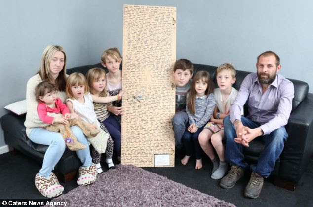 Athena's family - including mother Caroline, Naysa, Letissia-Dior, Indika-Mayah, Porscha, Ethan, Tiana, Harley and father Dean with the message they found on the back of Athena's mirror