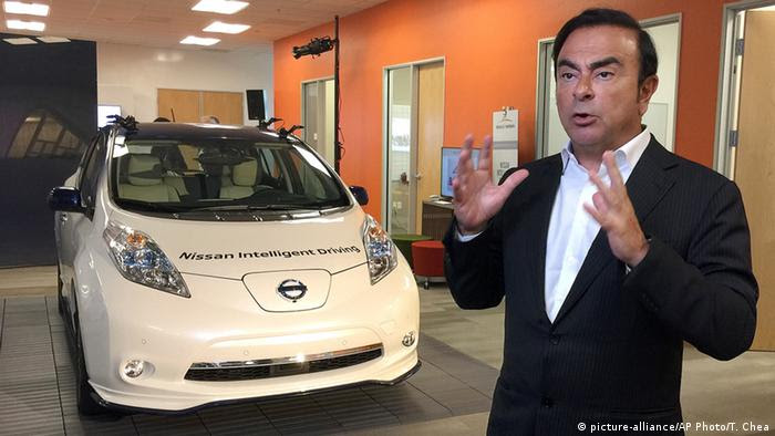 Carlos Ghosn, chairman and CEO of Nissan, speaks next to a prototype of the autonomous driving Nissan Leaf at Renault-Nissan Silicon Valley in Sunnyvale, Calif