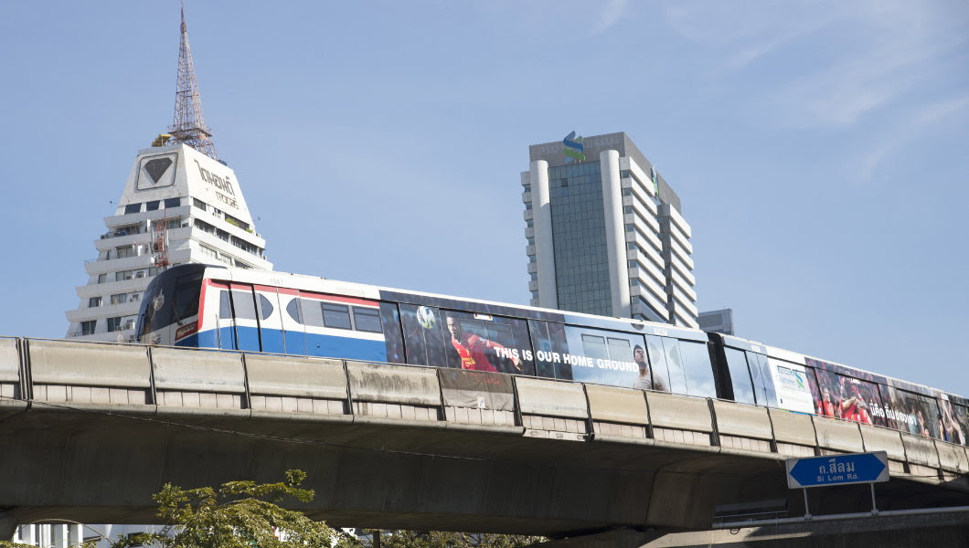 Mass transit sky train above Silom Road Bangkok Thailand