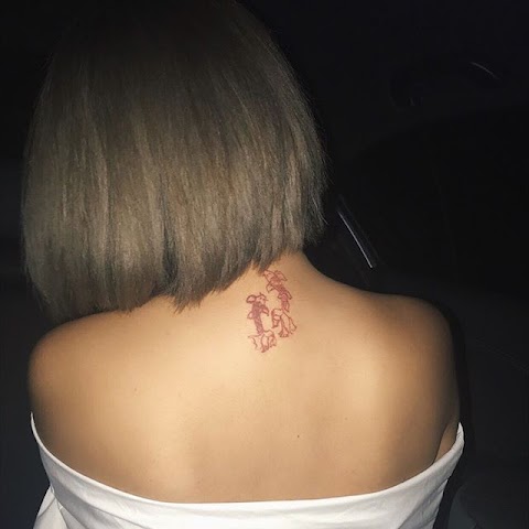 red ink dragon tattoo on neck