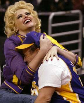 Smith, left, and Danny DeVito clown around during a Los Angeles Lakers' game in 2004. Photo: CHRIS CARLSON, Asssociated Press