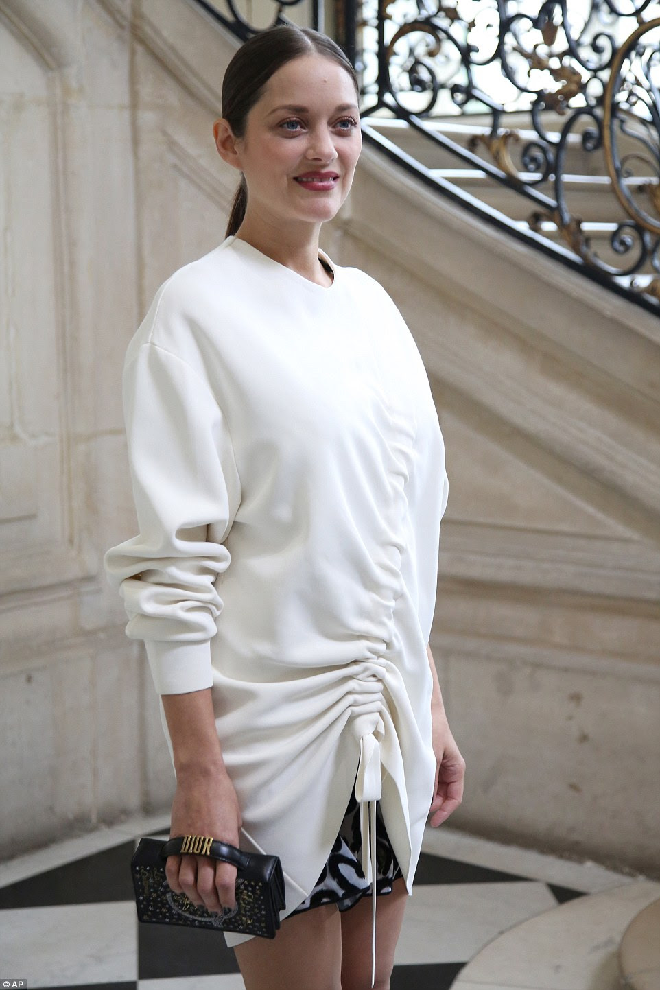 Stunning: She arrived in a stunning white top, which barely showed a hint of her baby bump