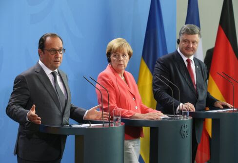 German Chancellor Angela Merkel, Ukrainian President Petro Poroshenko (R) and French President Francois Hollande speak to the media following talks at the Chancellery on Aug. 24, in Berlin.
