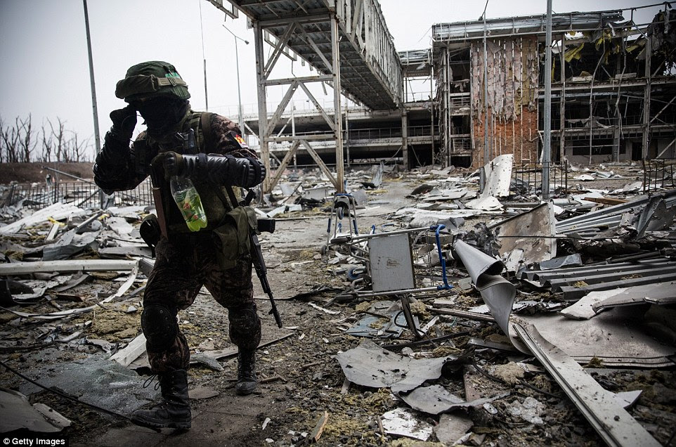 A rebel soldier makes his way through the debris which litters the ground of Donetsk airport