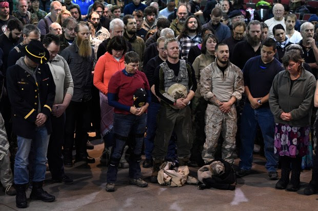 Wesley Clark Jr., far right, and other veterans pray during an emotional forgiveness ceremony at the Four Prairie Knights Casino and Resort on the Standing Rock Sioux Reservation on December 5, 2016 in Fort Yates, North Dakota. Native Americans conducted a forgiveness ceremony with U.S. veterans at the Standing Rock casino, giving the veterans an opportunity to atone for military actions conducted against Natives throughout history. The ceremony was held in celebration of Standing Rock protesters' victory Sunday in halting construction on the Dakota Access Pipeline.