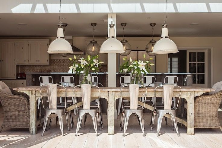 Grey rattan kubu chairs farmhouse-style dining room w/skylight
