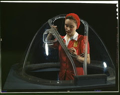 This girl in a glass house is putting finishing touches on the bombardier nose section of a B-17F navy bomber, Long Beach, Calif. She's one of many capable women workers in the Douglas Aircraft Company plant. Better known as the "Flying Fortress," the B-1