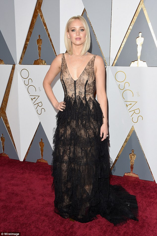 She's a lacy lady! Jennifer Lawrence shows off her toned figure in layered gown as she poses on Oscars red carpet on Sunday in Los Angeles