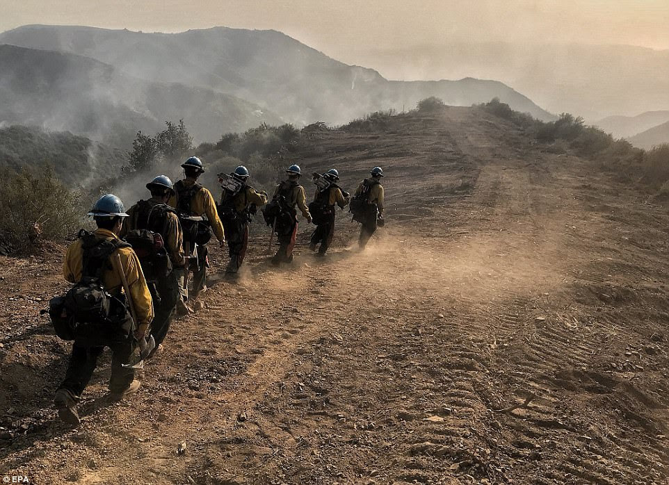A US Forest Service Hot Shot Crew from Ojai head down a fire break to work off East Camino Cielo as efforts to battle the Thomas Fire continue near Santa Barbara  on Sunday