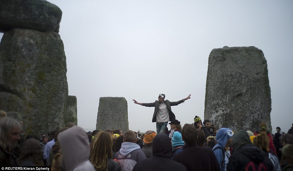Festivities: A reveller dances on a stone at ancient Stonehenge
