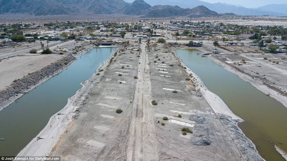 Water focused think tank The Pacific Institute estimated in a 2014 report that without significant steps to fix the Salton Sea, the costs over the next 30 years could range from $29billion to $70billion including higher health care costs for illnesses and lower property values. Pictured above is an aerial view showing vacant plots of land in Desert Shores