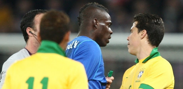 Atacante Balotelli (esq) e volante Hernanes discutem durante amistoso entre Brasil e Itália
